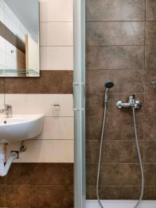 a bathroom with a shower and a sink at Aelia Rooms & Apartments in Ios Chora