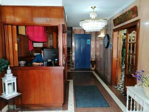 a hallway with a reception desk in a house at Hotel Las Rocas de Isla in Isla