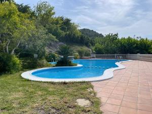 a swimming pool in the middle of a yard at La Caseta in Xàtiva