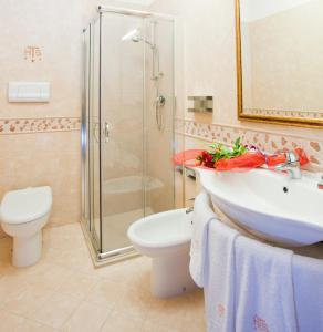 a bathroom with a sink and a toilet and a shower at Hotel Tito Serrano' in Melito di Porto Salvo