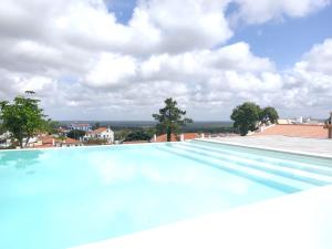 a large swimming pool on top of a building at Villa Vista in Sesimbra