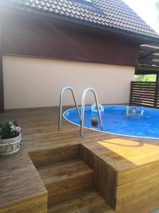 a backyard pool with a hot tub and a wooden floor at Chaty Ivana 18 a 19 u Hustopecskych jezer in Hustopeče Nad Bečvou