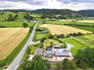 an aerial view of a house in the middle of a field at Maesnewydd Cottage in Welshpool