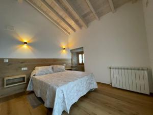 a bedroom with a large bed in a room at CASA DA ESCOLA in Lobios