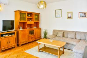 a living room with a couch and a tv at Apartman Gabrijela in Senj