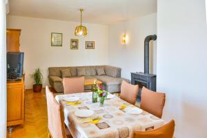 a living room with a table and a couch at Apartman Gabrijela in Senj