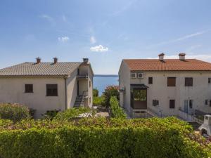 a view of two buildings with the ocean in the background at Apartments Elizabeta in Dramalj