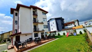 a building with tables and chairs in a yard at Elina2 in Techirghiol