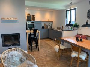 a kitchen and living room with a table and chairs at Haus & Hof Guest House in Perl