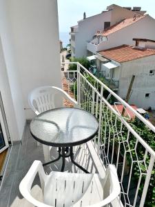 a table and chairs on a balcony with a view at Apartments Villa Antony 2 in Drvenik
