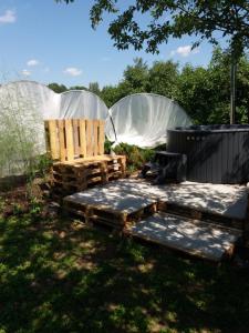 a garden with two domes and a bench in the grass at Augšistaba Beči in Vecumnieki +10 photos