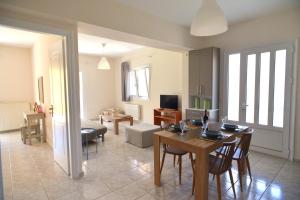 a living room with a table and a dining room at Arodo in Lefkada Town