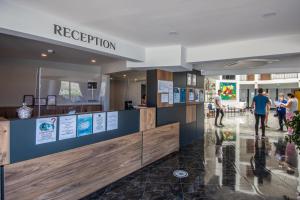 a reception area in a building with people walking around at Dalya Resort Aqua & Spa Hotel Datça in Datca +83 photos