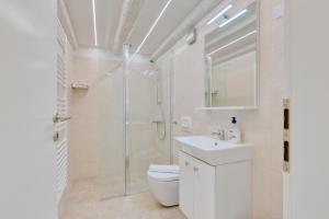a bathroom with a shower and a toilet and a sink at Apartment light in Pula in Pula