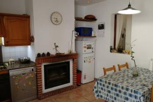 a kitchen with a table and a kitchen with a stove at Ses Venes 1 in Maria de la Salut