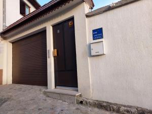 a building with a garage door and a sign on it at Residence Lubina in Sarajevo