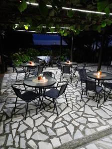 a group of tables and chairs on a patio at BATO Rooms in Peštani
