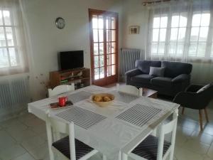 a living room with a table with a bowl of fruit on it at Petrochori Memories House- Floor 1 in Petrochori