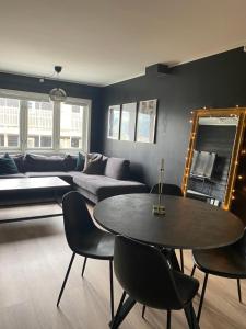 a living room with a table and a couch at Oppdal Alpintun ski in ski out in Oppdal