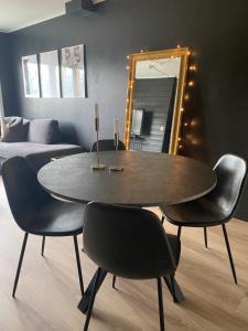 a dining room with a table and chairs and a mirror at Oppdal Alpintun ski in ski out in Oppdal