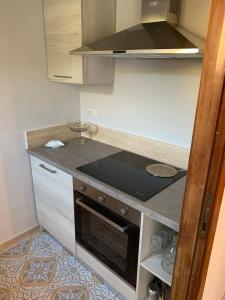 a small kitchen with a stove top oven at La Casa di Loris in Lerici