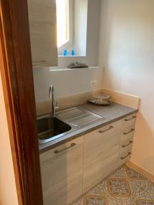 a kitchen with a sink and a counter top at La Casa di Loris in Lerici