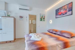 a room with a bed with pillows on it at Apartment light in Pula in Pula