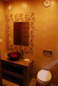 La salle de bains est pourvue de toilettes, d'un lavabo et d'un miroir. dans l'établissement Chatka nad jeziorem, à Studzienice