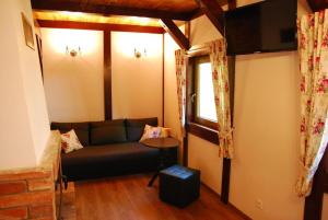 a living room with a couch and a table at Chatka nad jeziorem in Studzienice