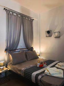 a bedroom with a large bed with a curtain at Μaria's flats in Tolo +10 photos