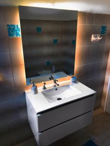 a bathroom with a white sink and a mirror at Μaria's flats in Tolo