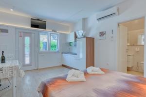 a bedroom with a bed with two towels on it at Apartment light in Pula in Pula