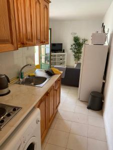 a kitchen with a sink and a refrigerator at Caletaparaiso110 in Costa de Antigua