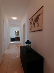 a living room with a black table and a map on the wall at Apartment Borovi with terrace and parking Podaca in Podaca