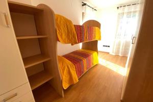 a room with a bunk bed and a closet at Mountain&Lake Apartment - CIPAT: 022104-AT-849776 in Levico Terme