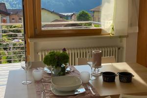 a table with a table cloth with a bowl and glasses at Mountain&Lake Apartment - CIPAT: 022104-AT-849776 in Levico Terme