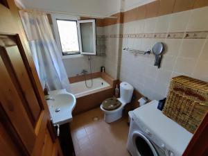 a small bathroom with a toilet and a sink at Good Vibes Villa in Eresos