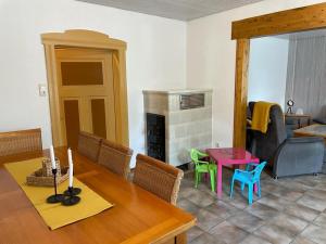 a living room with a table and chairs and a fireplace at Ferienwohnung Ram 1 in Hermannsburg