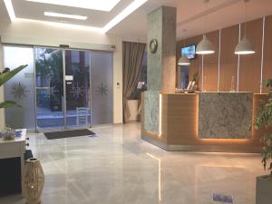 a lobby with a reception desk in a building at Voula Hotel in Hersonissos