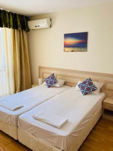 a bedroom with two beds and a window at Good Vibes apartment Avalon in Sunny Beach