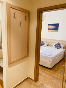 a small room with a bed and a mirror at Good Vibes apartment Avalon in Sunny Beach