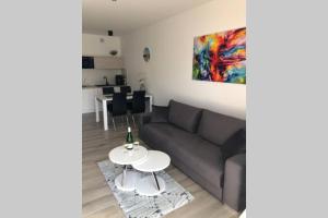 a living room with a couch and a table at Rewal Apartament "PANORAMA" in Rewal