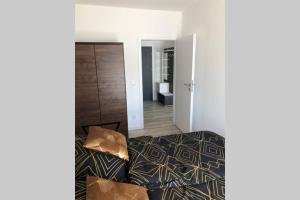 a living room with a couch and a bed at Rewal Apartament "PANORAMA" in Rewal