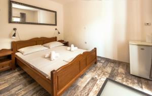 a bedroom with a bed with two candles on it at Apartments & Rooms Strčić Petra in Krk