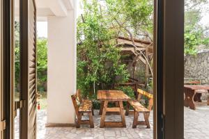 a table and chairs on the patio of a house at Apartments & Rooms Strčić Petra in Krk