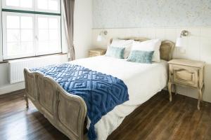 a bedroom with a large bed and a window at Tilia in Damme