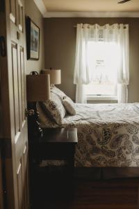 a bedroom with a bed and a window at Carriage House Inn Four and a Half Stars in Grand Falls -Windsor