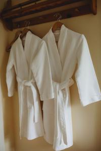 a group of white shirts hanging on a rack at Carriage House Inn Four and a Half Stars in Grand Falls -Windsor