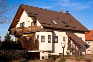 a large white house with a brown roof at Ferienwohnung Hetzdorf - Urlaub am Tharandter Wald in Hetzdorf
