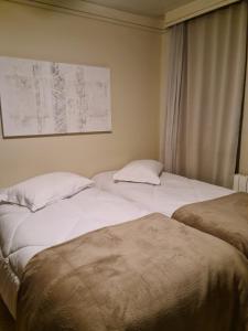 Un pat sau paturi într-o cameră la Alpenhaus Gramado Flat Temporada